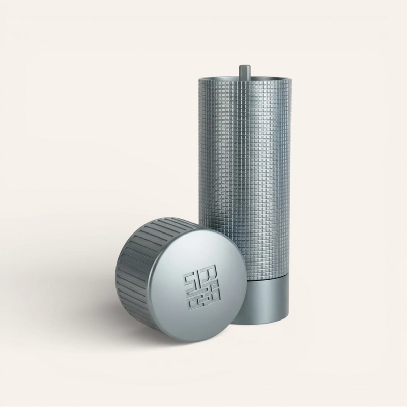 Siraat Salt Mill in titanium gray with its cap off beside it, a non-toxic refillable salt grinder