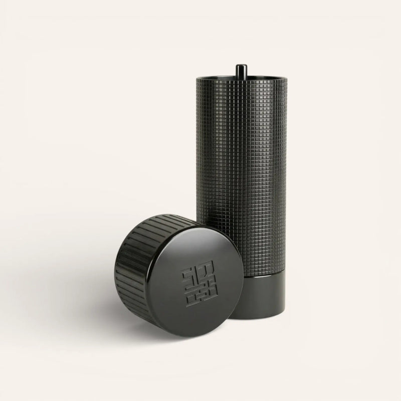 Siraat Pepper Mill in matte black with its cap off beside it, a non-toxic refillable pepper grinder