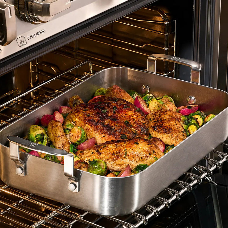 Roast chicken with vegetables in the Siraat Titanium Hammered Roasting Pan inside a hot oven