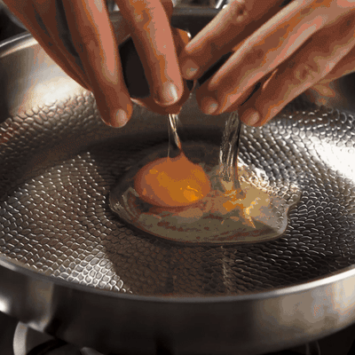An egg sliding in the Siraat Titanium Hammered Pan Pro