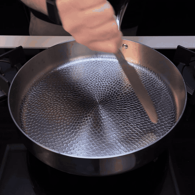 A knife dragged across the Siraat titanium cooking surface
